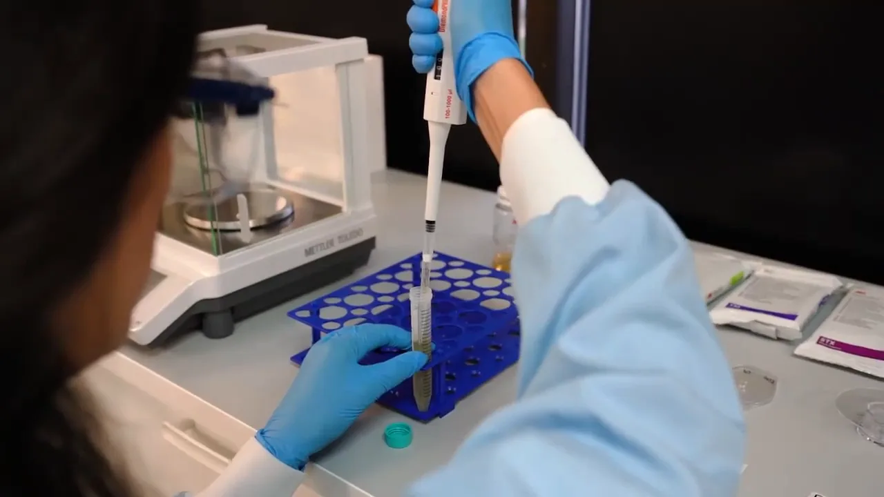 Analyst pipetting samples into tubes