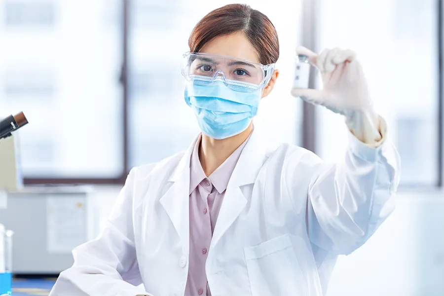 Analyst holding a sample vial in the laboratory